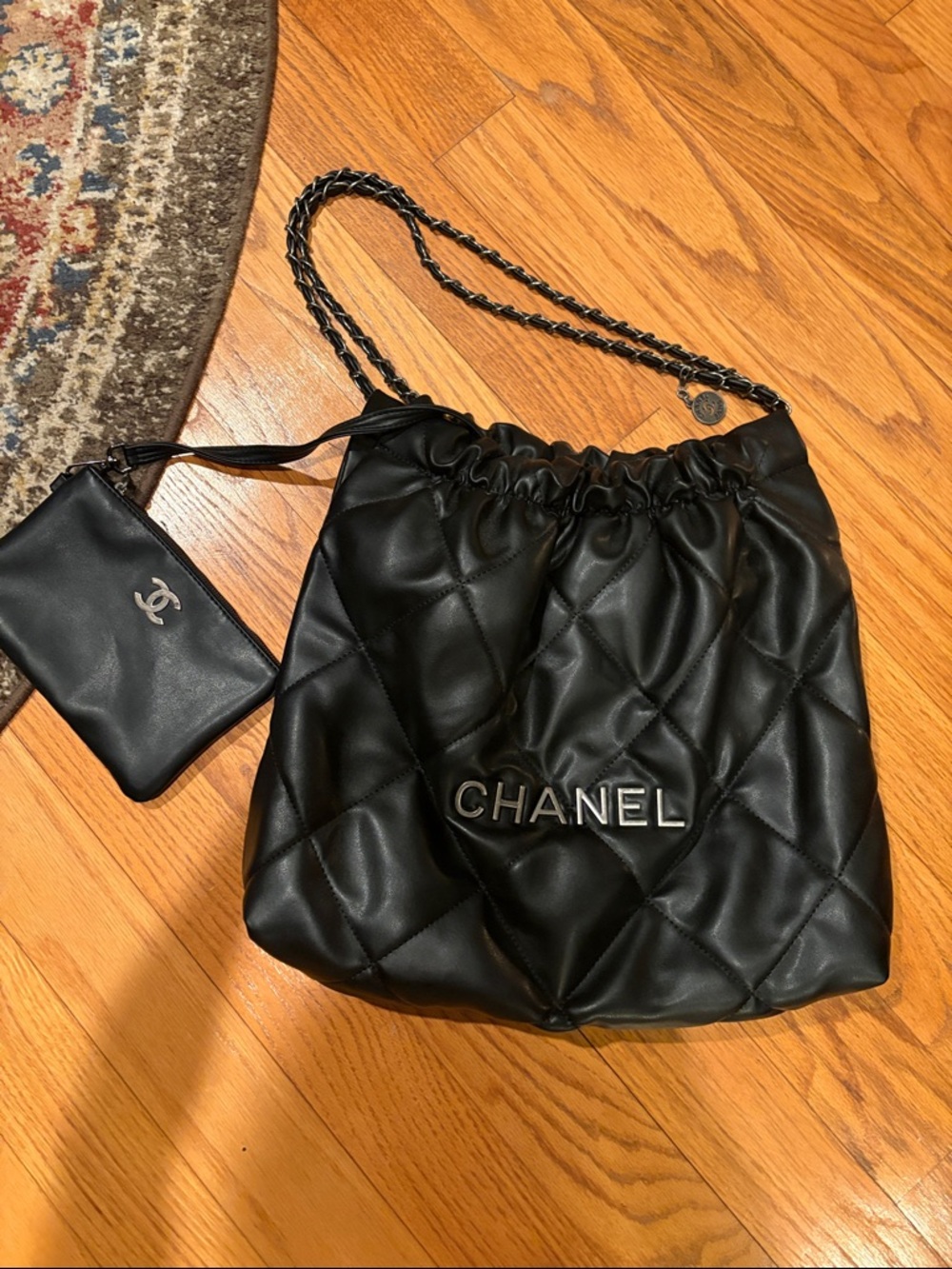 CHANEL Black Quilted Drawstring Shoulder Bag with Chain Strap and Pouch